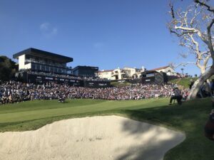 The crowd gathers around the 18th green at the Genesis Invitational in Los Angeles in 2020. This year's tournament will be relocated because of the wildfires in the region. File Photo by Tim Schneider/SportsTravel