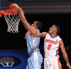 North Carolina's Brice Johnson dunks against Florida's Kasey Hill during the Battle 4 Atlantis 2014 championship game in the Bahamas. (AP Photo/Tim Aylen)