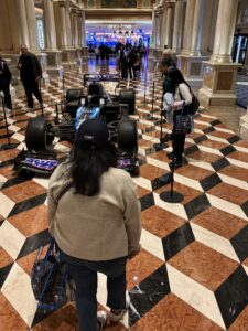 Race fans take a close look at the Alpine Formula 1 car that was on display in the lobby at the Venetian during race week ahead of the Las Vegas Grand Prix. Photo by Matt Traub/SportsTravel