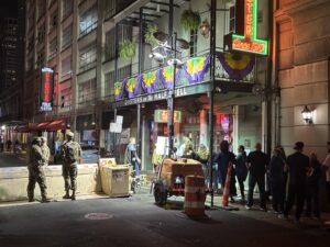Security guards man an area near Bourbon Street as people wait in line to get into an Oyster Bar on Wednesday night in New Orleans, which hosts the Super Bowl on Sunday evening. Photo by Matt Traub/SportsTravel